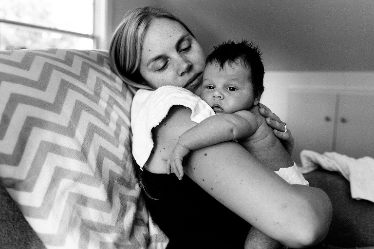 Black and white. Mom looks at newborn and newborn looks out the window. Very sweet. 