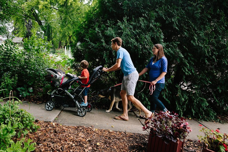 Family of four and family dog on a walk in the neighborhood. 