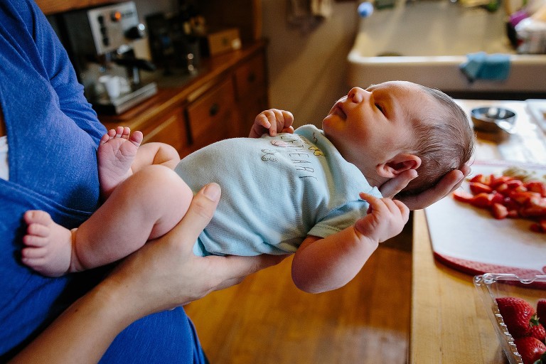 Newborn baby portrait. Strawberries in the background. 