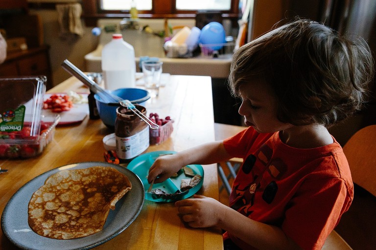 Boy eating Nutella crepes. 