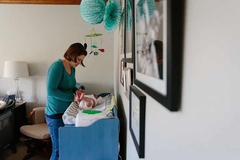 mom changes baby's diaper, newborn, four