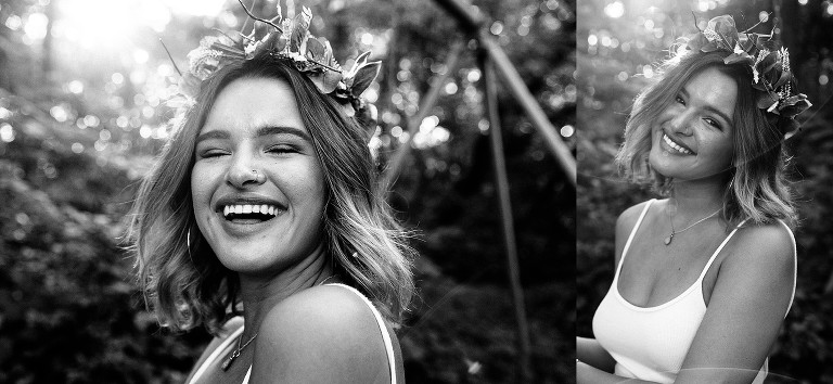 Black and white. Young woman laughs on swing set in forest.