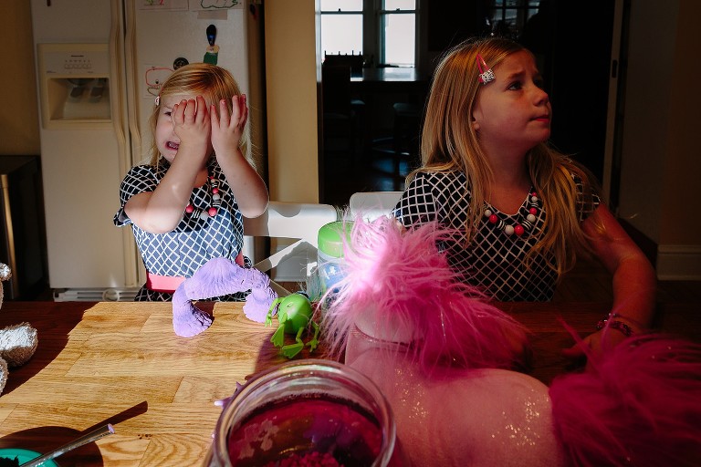 Toddler girl cries, she wipes her tears 