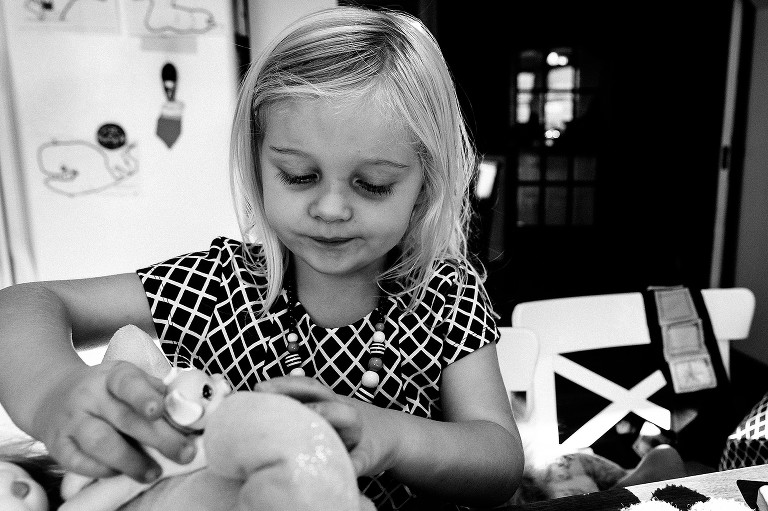 Toddler plays wiht toys at table 