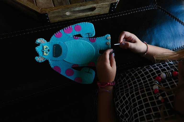 Girl finishes sewing craft.