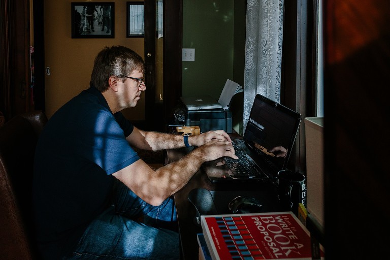 Dad works on laptop in the office 