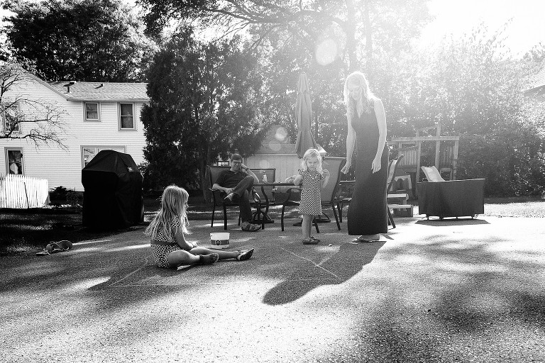Girls play Hopscotch in the back yard. 