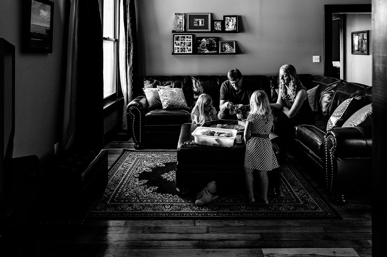 Family in living room, playing games and finishes sewing craft.