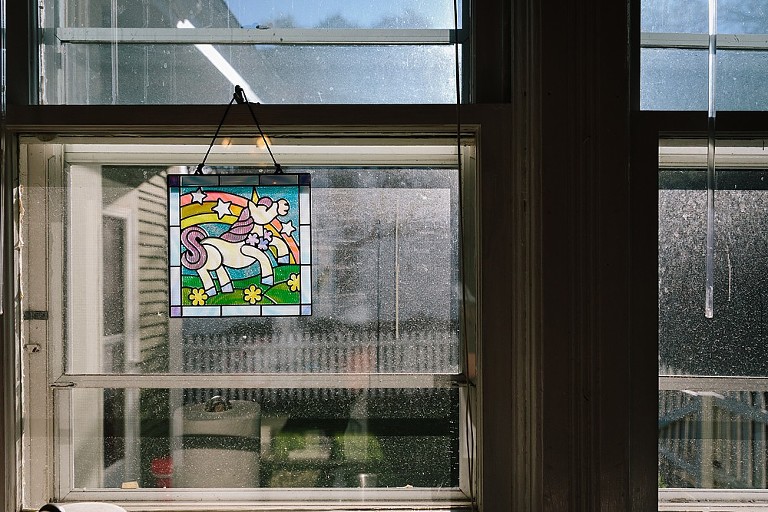 Rainbow unicorn stained glass in the kitchen window 