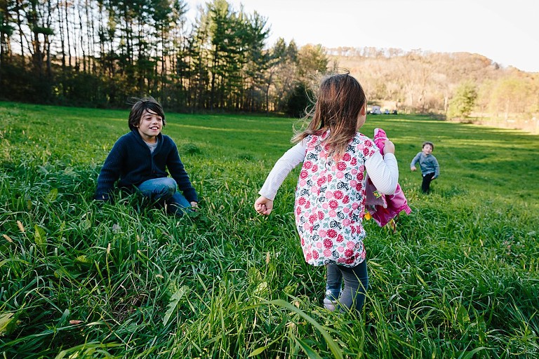 kids play on a hill. 