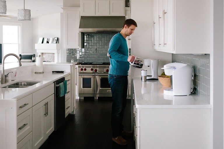 Dad making pot of coffee in kitchen