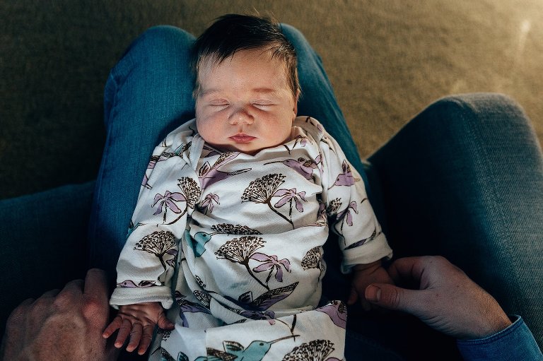 Sleeping newborn girl, holding Dad's hand 