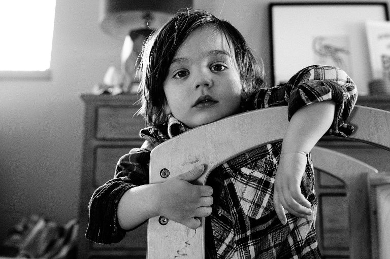 young boy with neutral expression in play structure