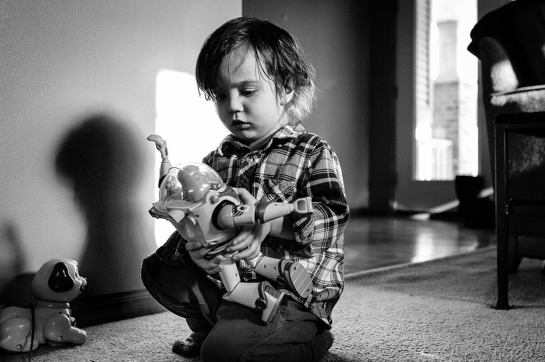 young boy plays with toy in house 