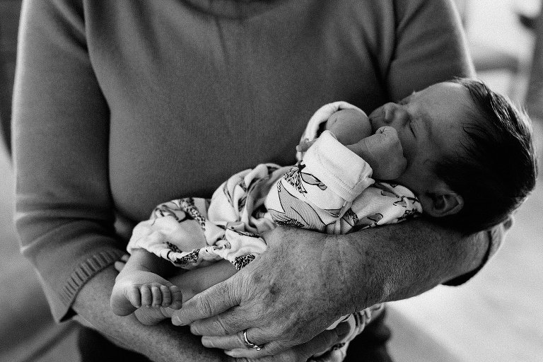 Grandma holds newborn granddaughter