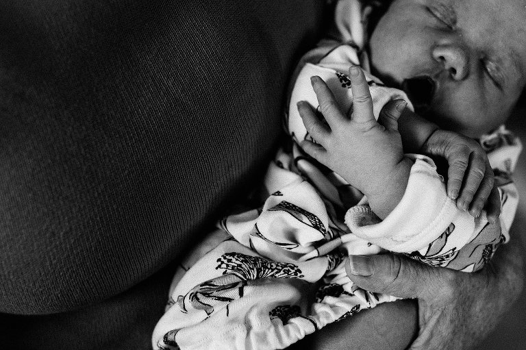 baby yawns, focus on newborn hands