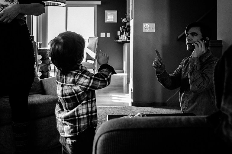 Dad and young boy have pretend phone call 