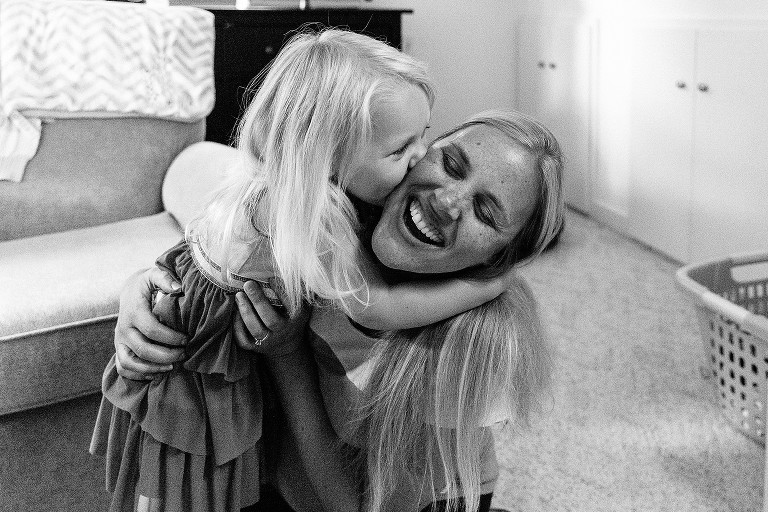 Daughter kisses joyful mother 
