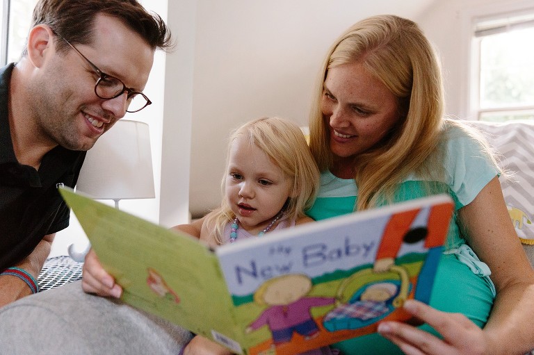 Family of three read about book about a New Baby 
