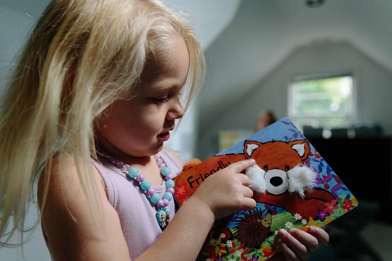 preschool girl shows book 