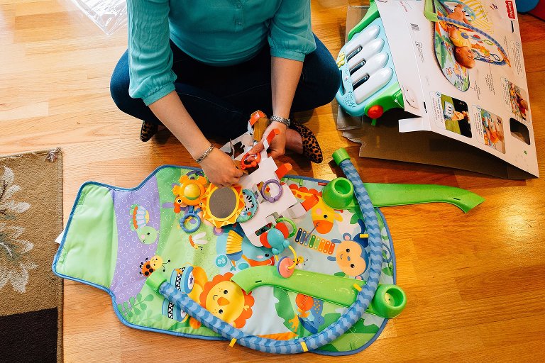 Expectant mother assembles baby play mat 