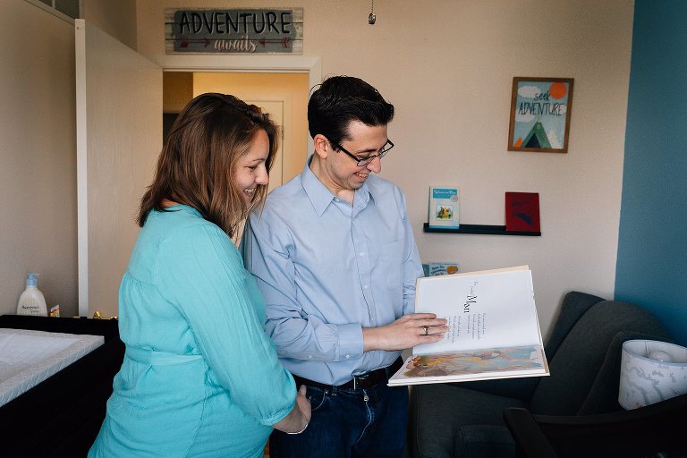 Parents read children books in nursery 
