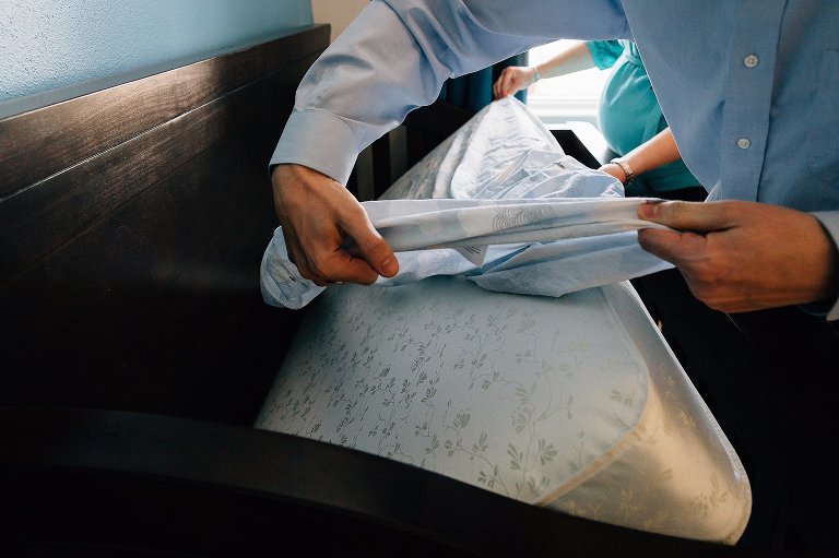 Parents assemble crib for newborn 
