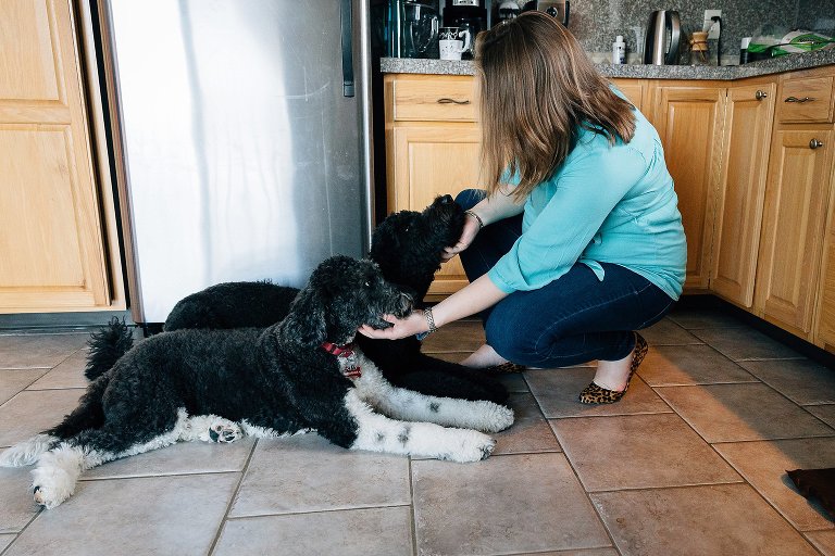Mother gives two dogs treats