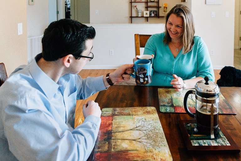 Expectant mother and father cheers a cup of coffee and tea 