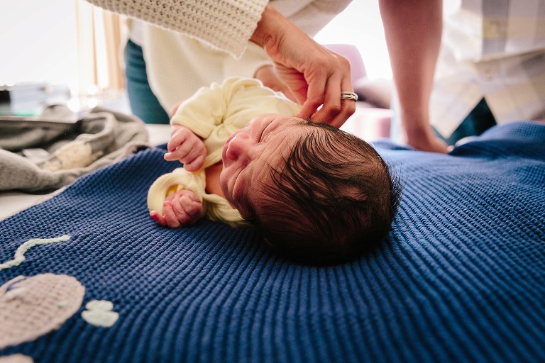 mom changes newborn clothes