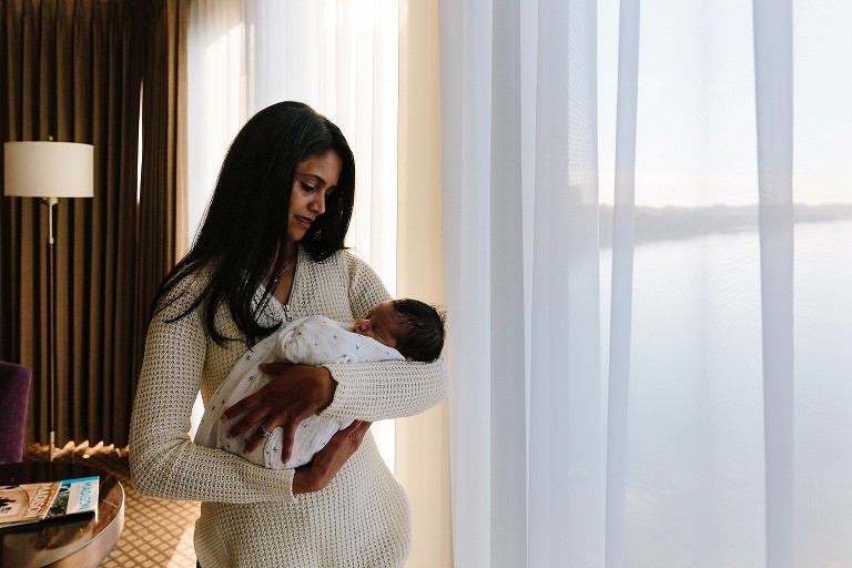 Newborn baby sleeps in mom's arms 