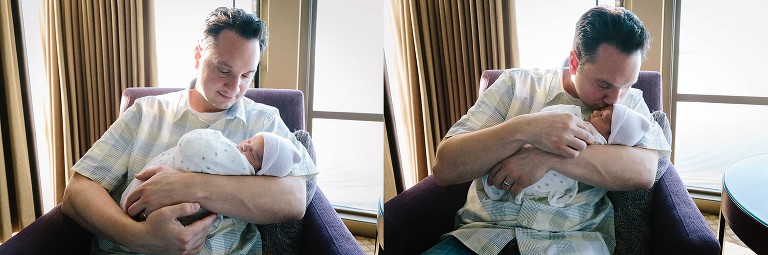 Newborn baby sleeps in dad's arms 