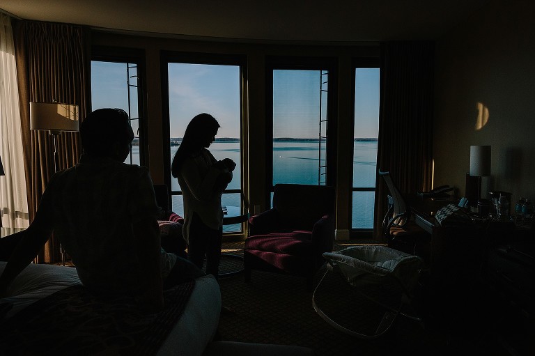 Mom soothes baby at hotel room on Lake Mendota. 