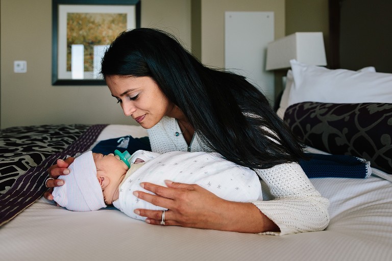 Mom engages wiht newborn eye contact 