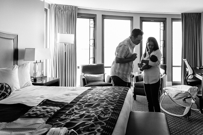 parents are in a hotel room with newborn baby