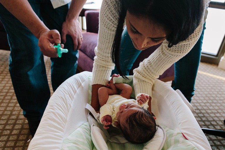 Both parents work to soothe crying baby