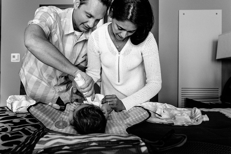parents change newborn's diaper 