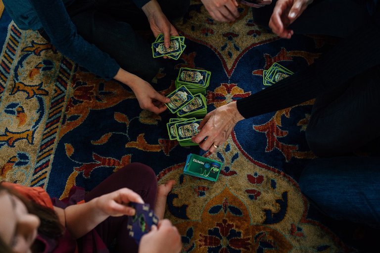 Hands of family playing card game