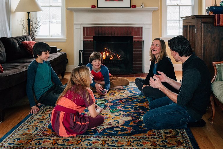 whole family having fun playing card game 