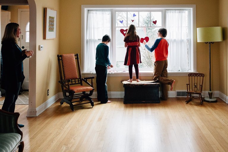 Kids had construction paper hearts, Mom watches with tea in hands