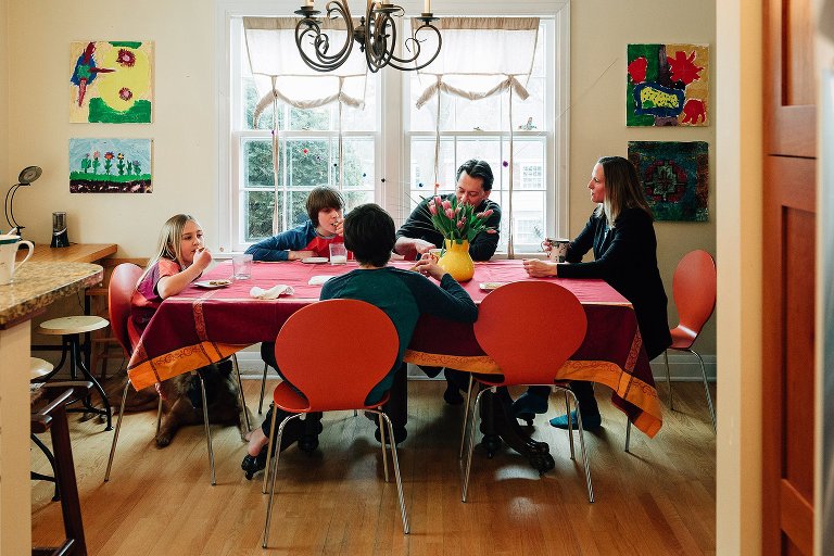 Family gathers at table for afternoon snack 