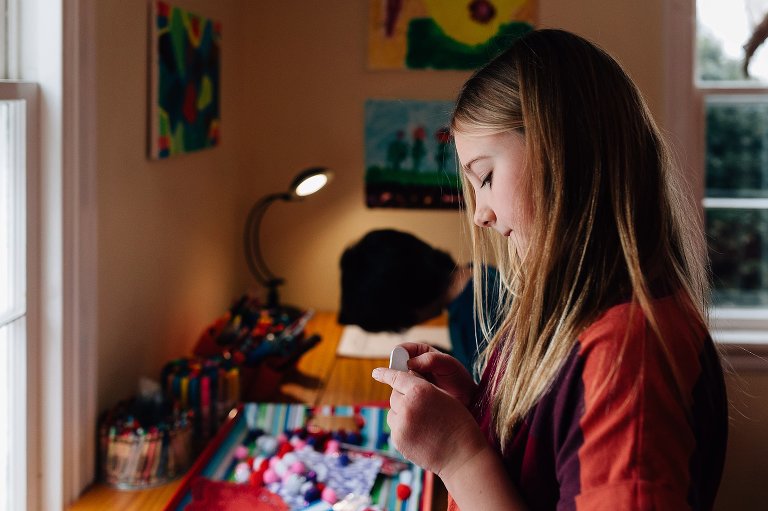 Young girl works on valentines 