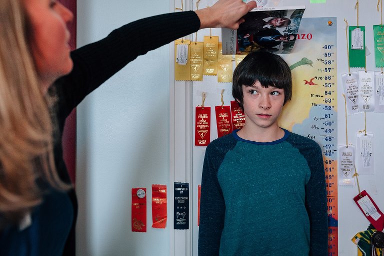 Mom measures boy's growth