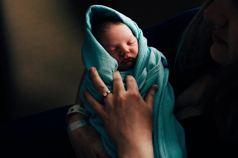 Sleeping newborn in hospital blanket