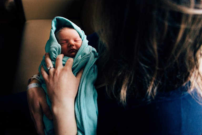 Sleeping newborn baby in traditional hospital blanket. 