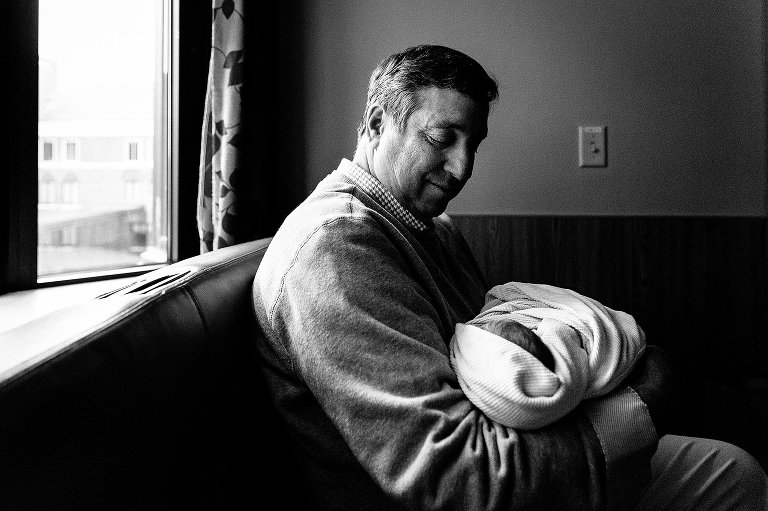 Grandpa holding newborn grandson