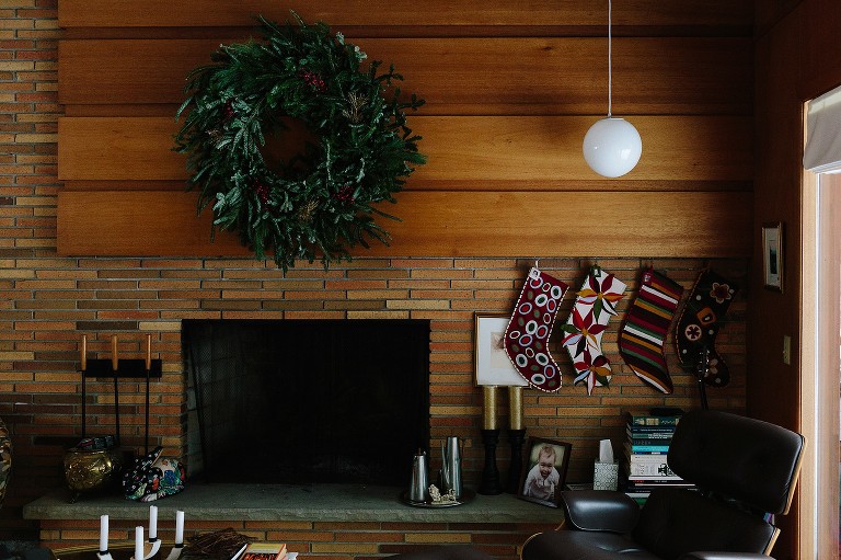 Christmas wreath and stocking hung by fireplace 