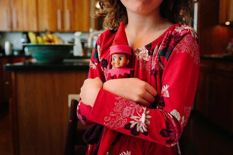 girl holds elf 