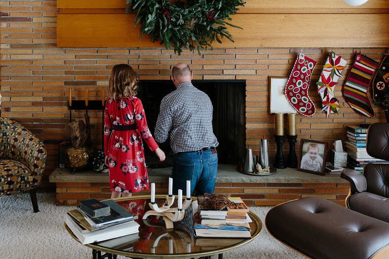 Dad and daughter start at fire in the fireplace 