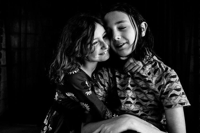 Portrait of boy and girl siblings, hugging 